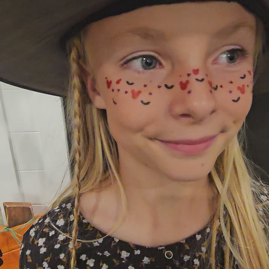 girl wearing mickey mouse and bat face freckles